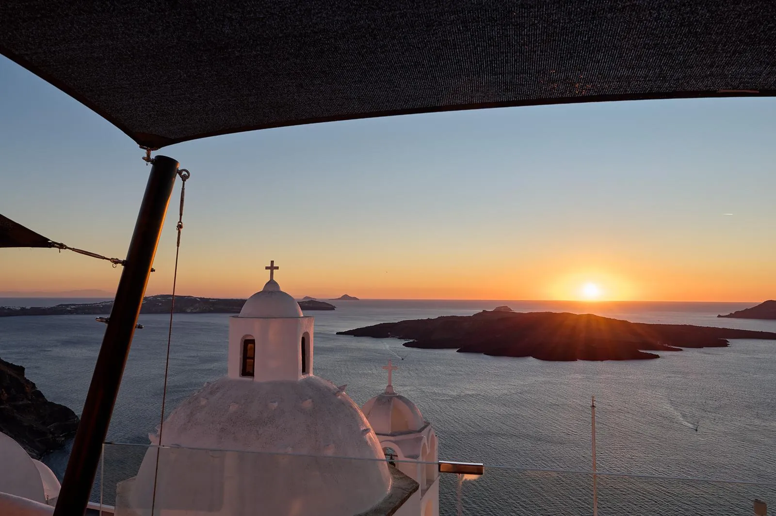 Whitewashed church dome overlooking the Santorini caldera from Fira